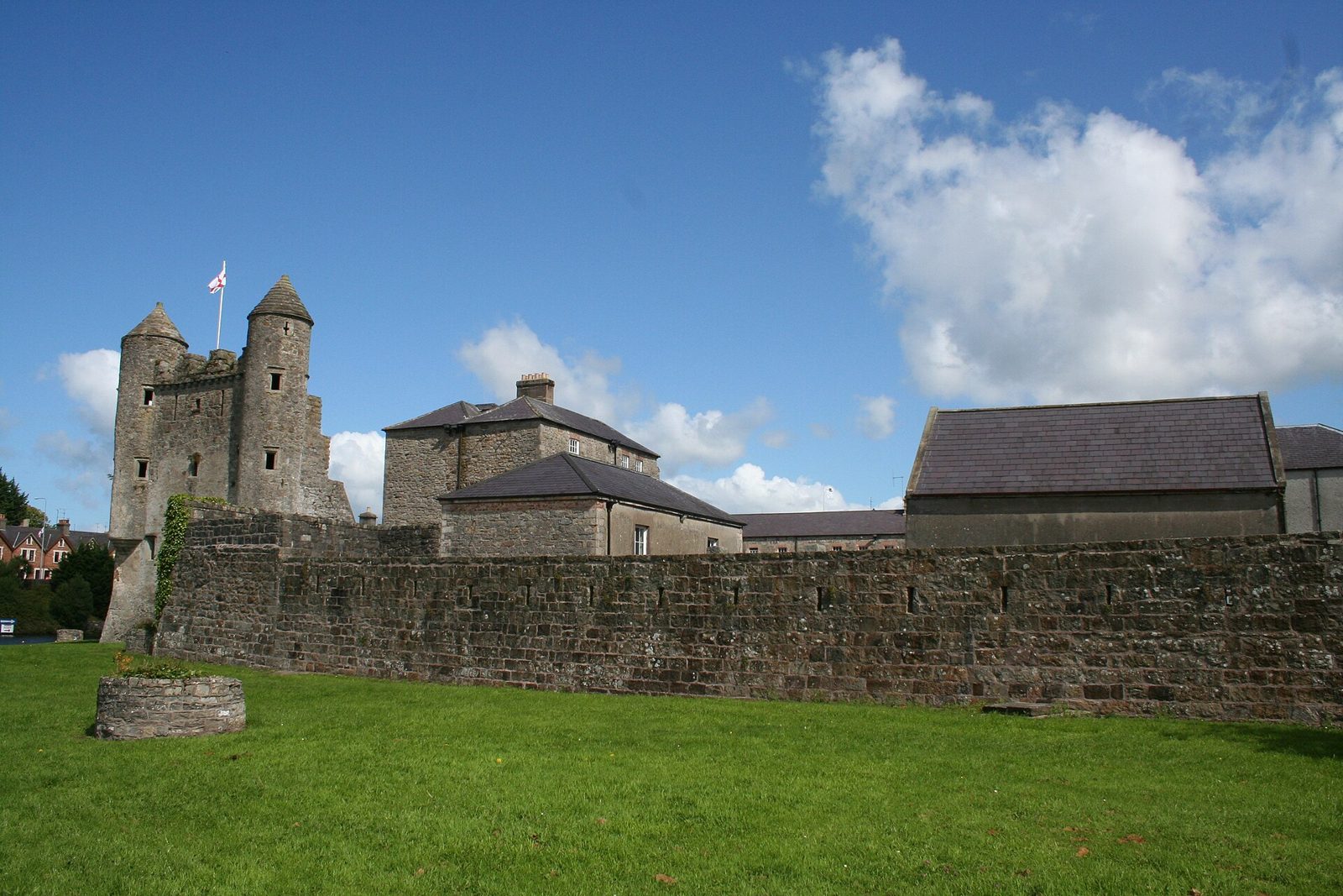 Enniskillen Castle keep and water gate towers above a green lawn under a blue sky