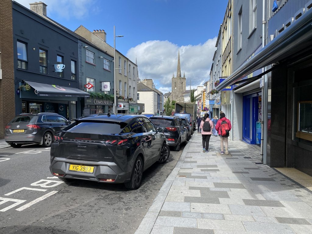 Shops and the cathedral spire along High Street in Enniskillen town centre
